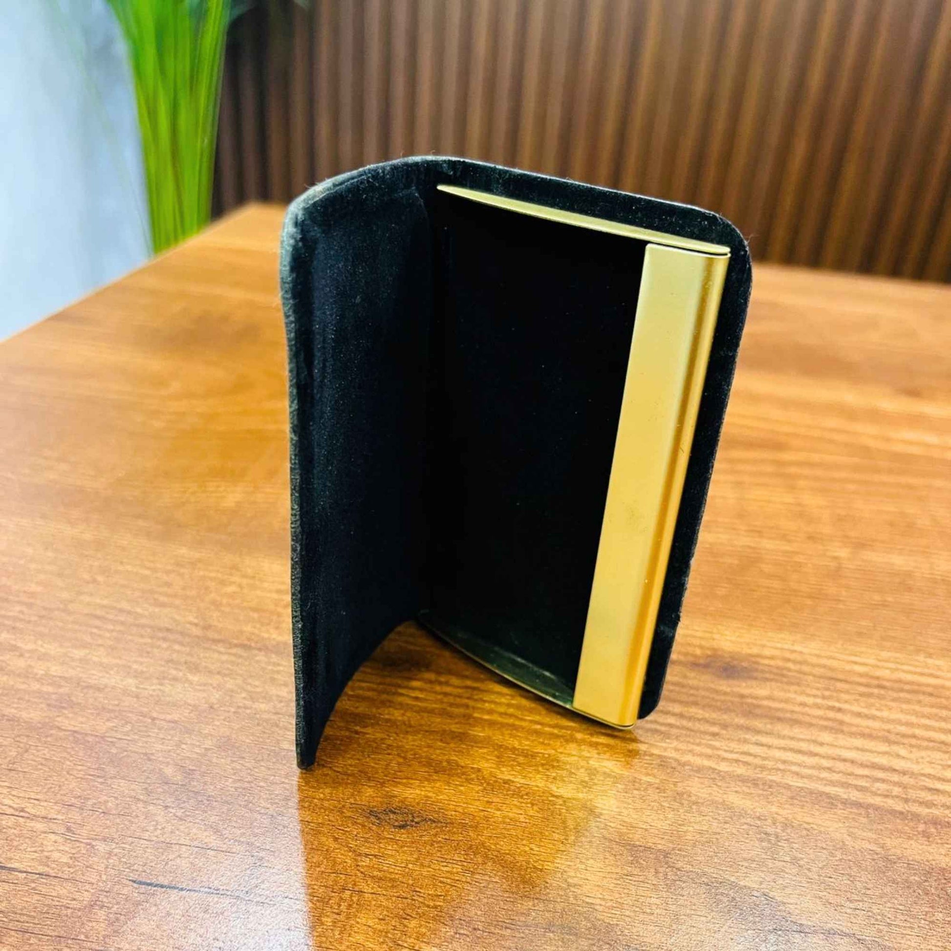 Green leather and metal business card holder for professional card storage and executive use